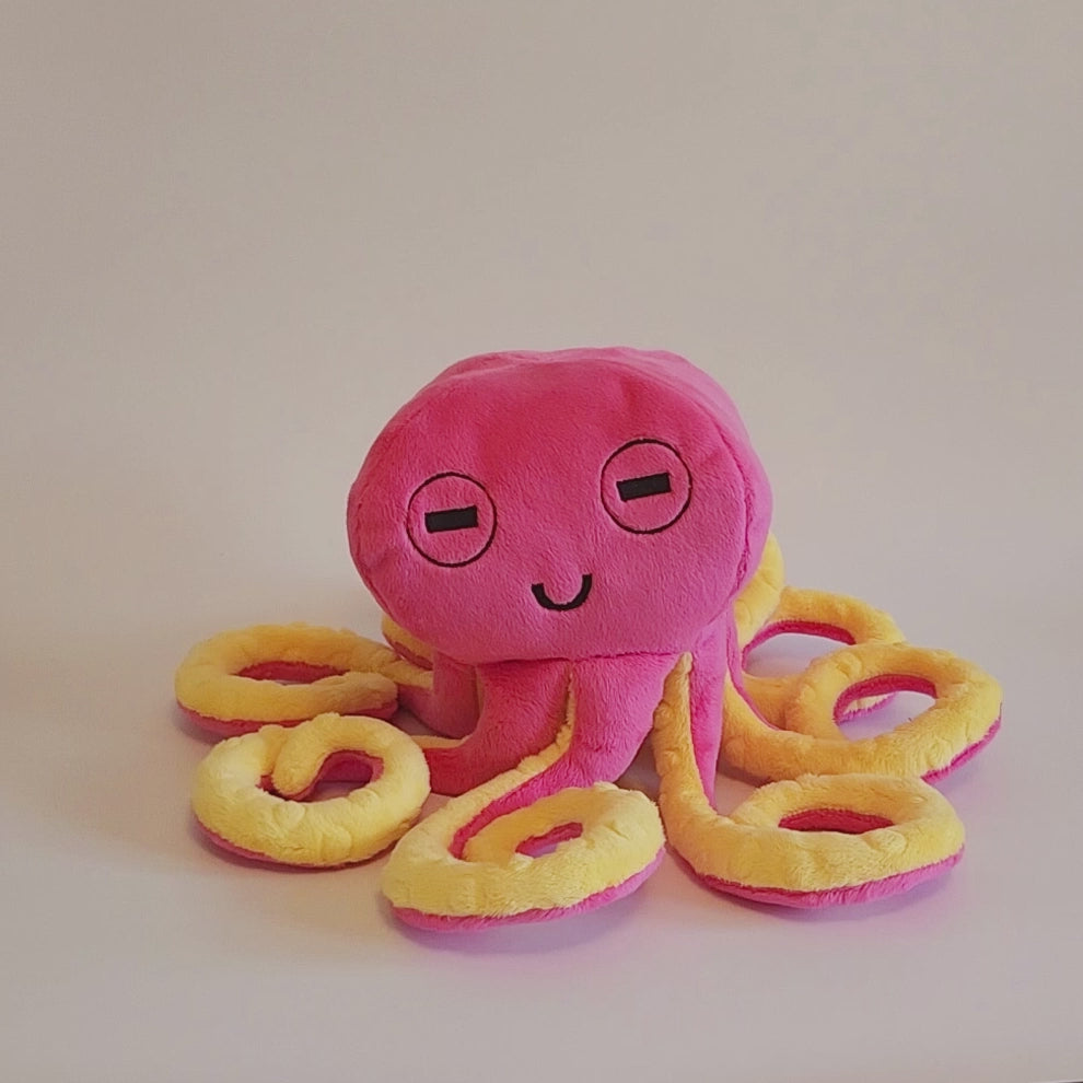 Video of pink octopus with yellow tentacles and an embroidered face
